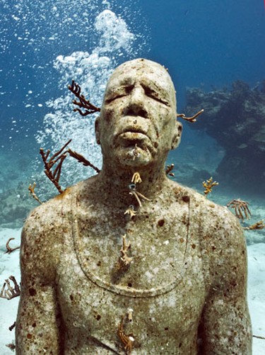 Seen here is one of the 400 human figures that constitute an exhibit of underwater sculpture called "The Silent Evolution" in Cancun, Mexico. British artist Jason deCaires Taylor describes the installation, which opens later this month, as the largest collection of contemporary underwater sculpture in the world. It will constitute the Cancun Underwater Museum of Art. JASON DECAIRES TAYLOR/AFP PHOTO