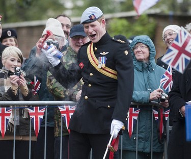 Prince Harry struggles with his klaxon horn at the  Wootten Bassett Field of Remembrance at Lydiard Park in Wiltshire, England, on November 9, 2010. WENN.COM