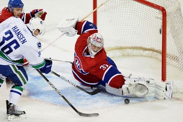 Montreal Canadiens' goalie Carey Price makes a save on the Vancouver Canucks' Jannik Hansen during the third period of their NHL ice hockey game in Montreal November 9, 2010. JOCELYN MALETTE/QMI AGENCY