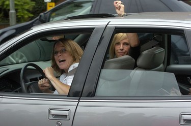 Motorists  crank the music as they pass the crowd on Ridout Street.  SUE REEVE The London Free Press