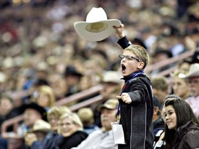 A young rodeo fan cheers during the Canadian Finals Rodeo at Rexall Place in Edmonton, Alberta on November 11, 2010.   (JORDAN VERLAGE/EDMONTON SUN)