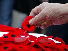 Poppies are placed on the Tomb of the Unknown Soldier following a Remembrance Day ceremony at the National War Memorial. File photo