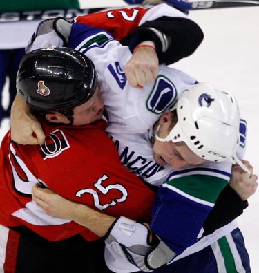 Ottawa Senators' Chris Neil (25) fights Vancouver Canucks' Rick Rypien (37) during the second period of NHL action at Scotiabank Place Thursday, November 11, 2010. (Darren Brown/Ottawa Sun)