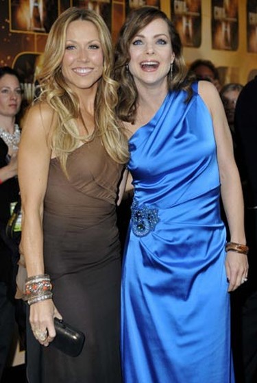 Singer Sheryl Crow (L) poses with actress Kimberly Williams as they arrive at the 44th annual Country Music Association Awards in Nashville, Tennessee November 10, 2010. REUTERS/Tami Chappell