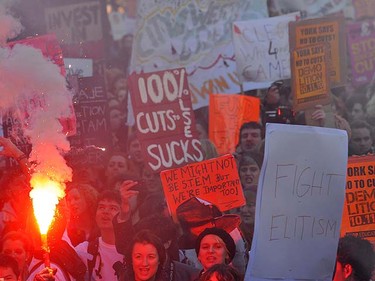 Students demonstrating against higher tuition fees burned placards, scuffled with riot police and smashed windows at the headquarters of Britain's governing Conservative party on Wednesday, Nov. 10, 2010.    REUTERS/Toby Melville