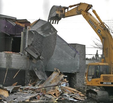 Workers remove debris at the site of the demolition of one of Ottawa's biggest eyesores, the so-called Vox Lounge building in Bells Corners on Monday, Nov. 8. The city and site owner Suncor hope to entice a hotel for the prime commercial site. (DOUG HEMPSTEAD Ottawa Sun)