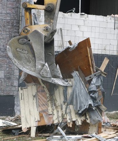 Workers remove debris at the site of the demolition of one of Ottawa's biggest eyesores, the so-called Vox Lounge building in Bells Corners on Monday, Nov. 8. The city and site owner Suncor hope to entice a hotel for the prime commercial site. (DOUG HEMPSTEAD Ottawa Sun)