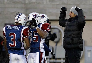 Montreal Alouettes quarterback Anthony Calvillo (R), who is not dressed for the game, makes a call from the sidelines during the first half of CFL football action against the Toronto Argonauts in Montreal, on Nov. 7, 2010. (REUTERS)