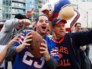 Chicago Bear fans go after Buffalo fan Adam Barber, 24, from London. Barber was trying to hit a target with the ball but didn't have much luck with this crowd after him. (CRAIG ROBERTSON, Toronto Sun)