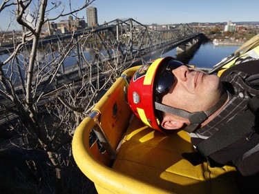 Ottawa Sun reporter Doug Hempstead gets "rescued" by Ottawa firefighters during a high-angle rescue exercise at Nepean Point on Tuesday, Nov. 2. TONY CALDWELL/Ottawa Sun