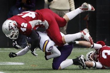 Nov 6/2010 The Ottawa Gee-Gees took on the Wilfrid Laurier Golden Hawks during the OUA semi-final at Frank Clair Stadium Sunday afternoon. Ottawa Gee-Gee James McNaughton tackles Golden Hawk Dillon Heap during first half action.   Tony Caldwell/Ottawa Sun