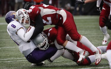 Nov 6/2010 The Ottawa Gee-Gees took on the Wilfrid Laurier Golden Hawks during the OUA semi-final at Frank Clair Stadium Sunday afternoon. Ottawa Gee-Gees James McNaughton and Nick Lecour take down Golden Hawk QB Shane Kelly during first half action.   Tony Caldwell/Ottawa Sun