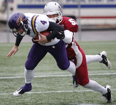 Nov 6/2010 The Ottawa Gee-Gees took on the Wilfrid Laurier Golden Hawks during the OUA semi-final at Frank Clair Stadium Sunday afternoon. Ottawa Gee-Gee Tyler Sawyer tackles Golden Hawk Evan Pawliuk during first half action.   Tony Caldwell/Ottawa Sun