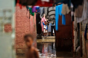 Haitians wait for help after a drain flooded their neighborhood of Cite-Soleil in Port-au-Prince on Nov. 6, 2010. Hurricane Tomas soaked Haiti's crowded earthquake survivors' camps and swamped coastal towns on Friday, triggering flooding and mudslides that killed at least seven people. (REUTERS)