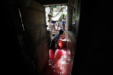 Haitian children clear water from their home after a drain flooded their neighborhood of Cite-Soleil in Port-au-Prince on Nov. 6, 2010. Hurricane Tomas soaked Haiti's crowded earthquake survivors' camps and swamped coastal towns on Friday, triggering flooding and mudslides that killed at least seven people. (REUTERS)