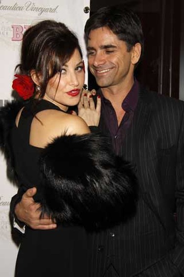 Gina Gershon and John Stamos pose during an opening night after party for the Broadway musical  'Bye Bye Birdie'  in 2009. (Joseph Marzullo/Wenn.com)