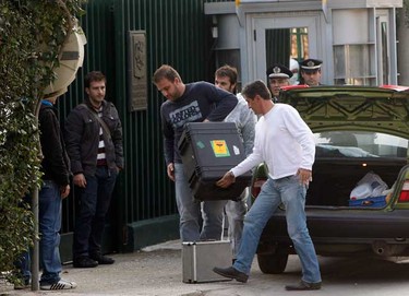 Plain clothes policemen carry equipment into the Russian embassy following an explosion in Athens Nov. 2, 2010. Bombs exploded at the Swiss and Russian embassies in Athens on Tuesday and police found suspect packages at two other embassies in a wave of parcel bomb attacks in the Greek capital.   (REUTERS)