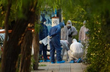 Police experts search for evidence outside a courier company where a package exploded in Athens Nov. 1, 2010. Greek police said it had intercepted on Monday a booby-trapped parcel addressed to French President Nicolas Sarkozy, after another package exploded at the courier company in Athens.  (REUTERS)
