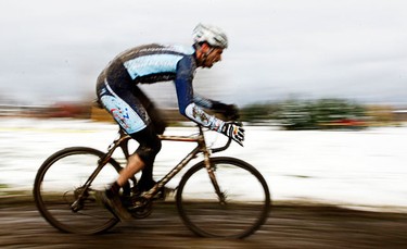 A rider is blurred as he rounds a corner leading up to the main climb. (Darren Brown/Ottawa Sun)