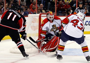 Ottawa Senators Daniel Alfredsson (11) tries to shoot on Florida Panthers goalie, Tomas Vokoun (29) while defended by Mike Weaver (43) during the first period of NHL action at Scotiabank Place Thursday, October 28, 2010. (Darren Brown/Ottawa Sun)