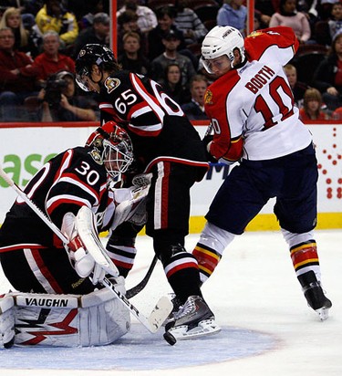 Ottawa Senators' goalie, Brian Elliott (30) stops the puck while under pressure from Florida Panthers' David Booth (10) defended by Ottawa Senators' Erik Karlsson (65) during the second period of NHL action at Scotiabank Place Thursday, October 28, 2010. (Darren Brown/Ottawa Sun)