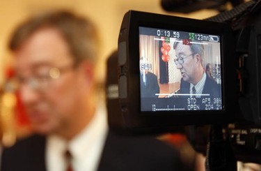 Jim Watson shows up in duplicate in a camera viewfinder during his victory party in Ottawa Monday night.   Tony Caldwell/Ottawa Sun