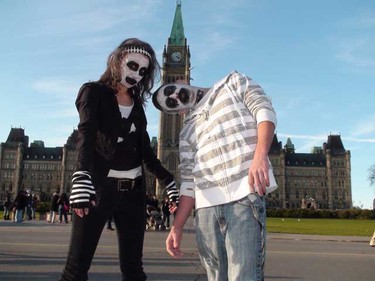 Tiffany Servage and Josh Proulx do the Zombie Walk on Parliament Hill Saturday afternoon. (Scott Taylor/Ottawa Sun)