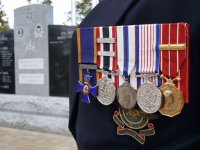 Oct 17/2010 With the support of the Navan community, the restored veterans memorial was unveiled Sunday to pay tribute to Navan-area residents who made the ultimate sacrifice in the service of their community. Navan, a town of 300 people in 1914, lost 15 soldiers in WW1.  Veterans watched the uncovering of the restored monument Sunday.   Tony Caldwell/Ottawa Sun