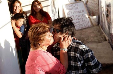 Miner Johnny Barrios kisses his girlfriend Susana Valenzuela moments after arriving home for the first time since being rescued in Copiapo on Oct. 15, 2010. Chile's rescued miners headed home on Friday as heroes after an ordeal deep underground during which they drank oil-contaminated water and set off explosives in a desperate bid to alert rescuers. (REUTERS)