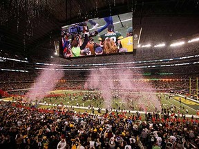 Green Bay Packers' Aaron Rodgers is seen on the big screen as the Packers celebrate their win over the Pittsburgh Steelers.  (REUTERS/Gary Hershorn)