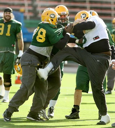 A fight broke out at the Edmonton Eskimos practice Wednesday  which saw Patrick Kabongo kick teammate Walter Curry twice, once hitting him in the groin area. It took numerous players and the head coach to help break up the on-field fight. In the middle trying to break up the fight is new defensive tackle Etienne Legare. (TOM BRAID/EDMONTON SUN)
