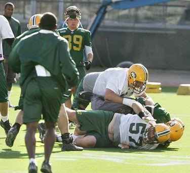 A fight broke out at the Edmonton Eskimos practice Wednesday  which saw Patrick Kabongo kick teammate Walter Curry twice, once hitting him in the groin area. It took numerous players and the head coach to help break up the on-field fight. In the middle trying to break up the fight is new defensive tackle Etienne Legare. (TOM BRAID/EDMONTON SUN)