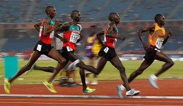 Uganda's Ndiema Moses Kipsiro (R) leads during the last lap of the men's 10,000 metres finals at the Commonwealth Games at Jawaharlal Nehru Stadium in New Delhi on Oct. 11, 2010. (REUTERS)