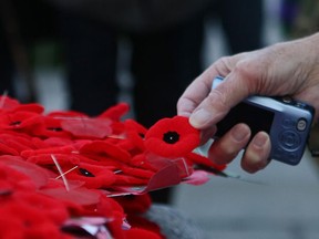 Poppies are pinned to the people's wreath during Remembrance Day ceremonies at the Queen's Park Veteran's Memorial in Toronto November 11, 2010. REUTERS/Mike Cassese