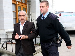 Kingston Police special constable Brian Hackett brings Mohammed Shafia of Montreal into county court in Kingston on Tuesday October 5th 2010 for the beginning of a preliminary hearing into the murder of three daughters of the Shafia family as well as Mohammed Shafia's ex-wife. The four women were found inside a submerged car in the Kingston Mills Locks on the Rideau Canal in June of 2009.  IAN MACALPINE KINGSTON WHIG-STANDARD QMI AGENCY