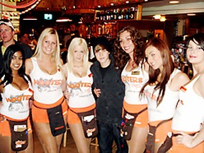 Singing sensation Justin Bieber is surrounded by Hooters girls, from left,  Anisa, Kristi, Caitlin, Tania, Mandy and Courtney. during his surprise visit to WEM Saturday afternoon. (PHOTO COURTESY HOOTERS EDMONTON)