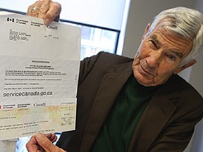 Columnist Peter Worthington holds up an Old Age Security and Canadian Pension Plan cheque from Clifford Olson who is incarcerated in a Quebec prison. The cheque is for 1169.47 and endorsed by Olson himself. (JACK BOLAND/QMI Agency)