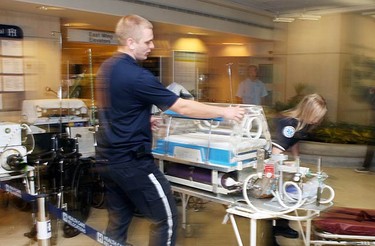 The transfer begins in the early morning on Grenville Ave. at the Women's College Hospital on Sept. 12, 2010. (VERONICA HENRI, Toronto Sun)