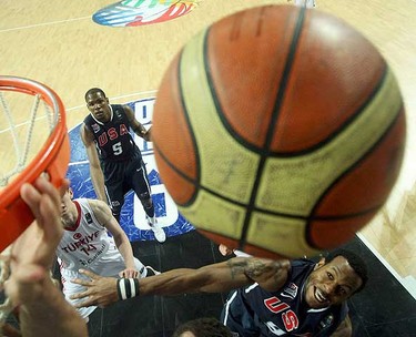 Kevin Durant and Andre Iguodala (R) of U.S. fight for a rebound with Turkey's Omer Asik (L) during their FIBA Basketball World Championship final game in Istanbul, September 12, 2010.   REUTERS/Jeff Haynes (TURKEY  - Tags: SPORT BASKETBALL)