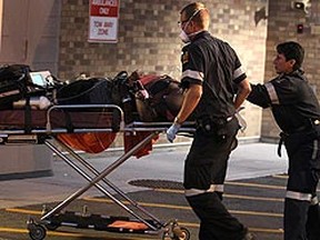 Paramedics arrive at Sunnybrook hospital with one of the two shooting victims. (JOHN HANLEY, Special to the Toronto Sun)