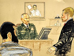 Omar Khadr, left, looks on as Col. W. testifies at Khadr's trial in a Guantanamo Bay courtroom Thursday. (Reuters)
