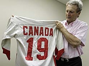 Paul Henderson holds the jersey he wore when he scored the winning goal during the 1972 Summit Series against the Soviet Union on June 7, 2010. (REUTERS/Mike Cassese)