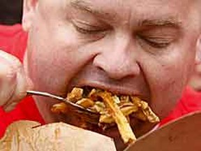 The winner of the World Poutine Eating championship sucked up 5.9 kilos of the gooey grub Saturday at BMO Field. (MARK O'NEILL, Toronto Sun)