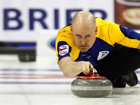 Alberta skip Kevin Koe delivers a shot during his team's win over Newfoundland and Labrador in their playoff game at the Brier curling championships in Halifax on March 13, 2010. Alberta won the playoff 6-5 and advance to the semifinal. (REUTERS)