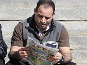 Accused terrorist Mohamed Harkat reads the Ottawa Sun during a break in a federal court hearing into his deportation held in 2012. ANDRE FORGET/QMI Agency
