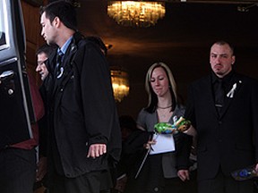 The parents of Keagan Davis, Daniel Davis and Leigh-Ann Cooper, watch as their son's white casket is placed in a hearse outside of the Oshawa Funeral Home. (Veronica Henri/Toronto Sun)