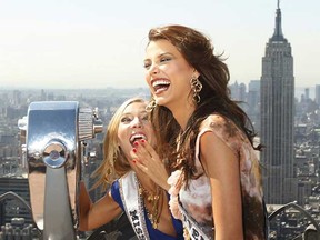 Miss Universe, Stefania Fernandez, of Venezuela and Miss USA, Kristen Dalton (R), smile while posing for photographers on the "Top of the Rock" observation deck at the Rockefeller Center in New York.  (REUTERS/Lucas Jackson)