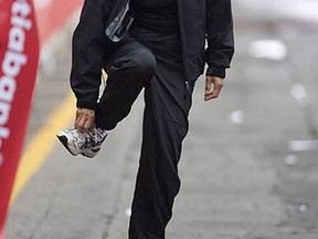 NDP MP Olivia Chow adjusts her running shoes at the Toronto Waterfront Marathon finish line in 2009. (STAN BEHAL, Sun Media)