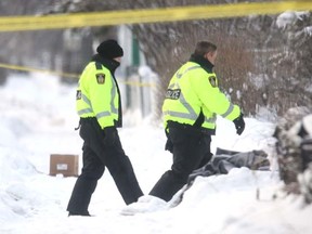 Police investigate the fatal shooting of Shawn Beauchamp, 26, in the area of Charles Street and St. John's Avenue on Jan. 11, 2009. His death was deemed the first homicide of the year. (JASON HALSTEAD/SUN MEDIA)