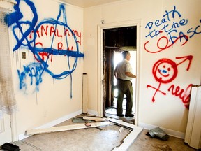 Carmen Argentina surveys the grafitti and damage done to a house he owns on Lyon Street. June 16, 2009 (Errol McGihon Sun Media)